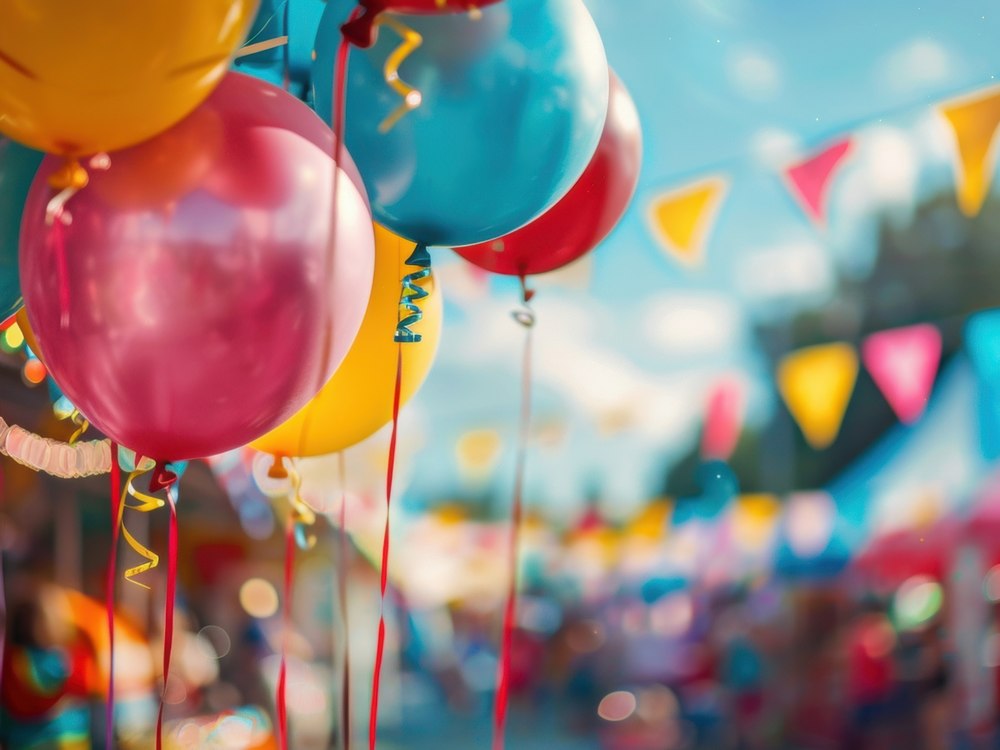 Colorful balloons and festival bunting flags at a community event